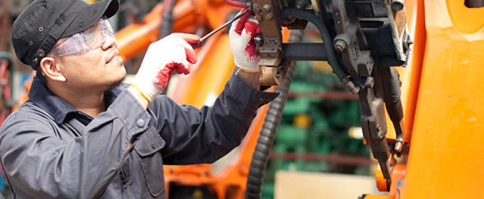 mechanic repairing a robot machine